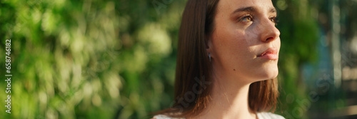 Canvastavla Portrait of young woman with freckles and dark loose hair wearing white top and