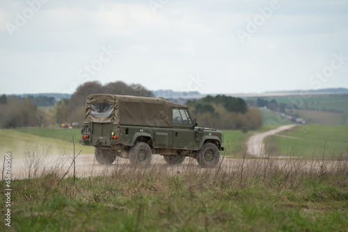 Photo British army Land Rover Wolf with Canvass Roof back top, driving along a dirt tr