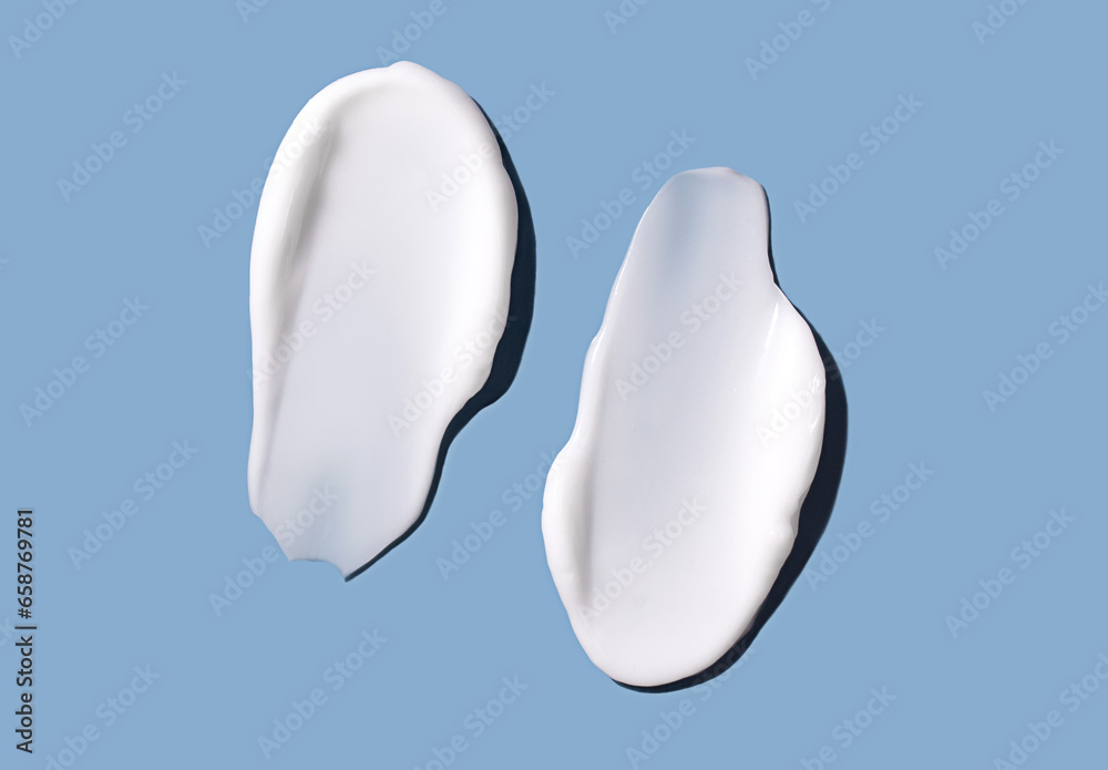 Cosmetic smear of cream texture on a blue background. Skin care. Cosmetic smear of cream texture on a blue background. Skin care.