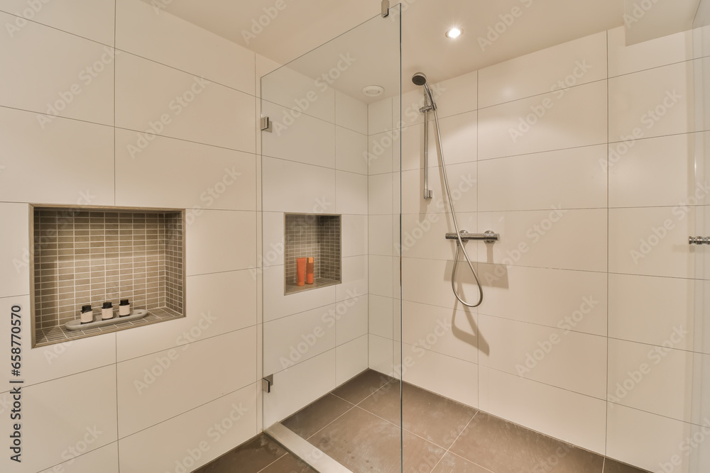 a walk in shower with glass doors and tile flooring on the wall next to it is a small window that looks out into