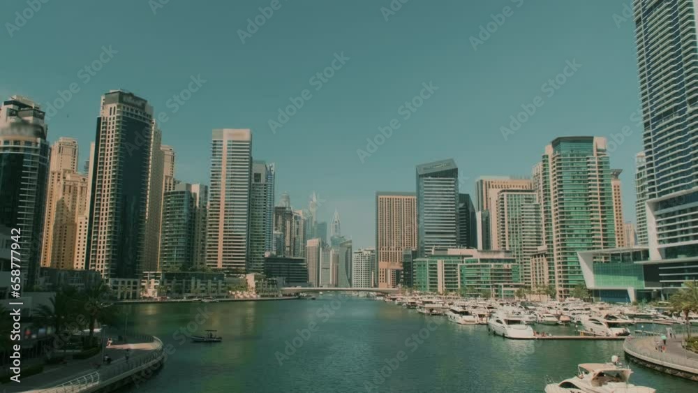 Skyscrapers in Dubai. A ship sails along a river in the United Arab Emirates. Magnificent landscape in a modern city. Skyscrapers in Dubai. A ship sails along a river in the United Arab Emirates. Magnificent landscape in a modern city.