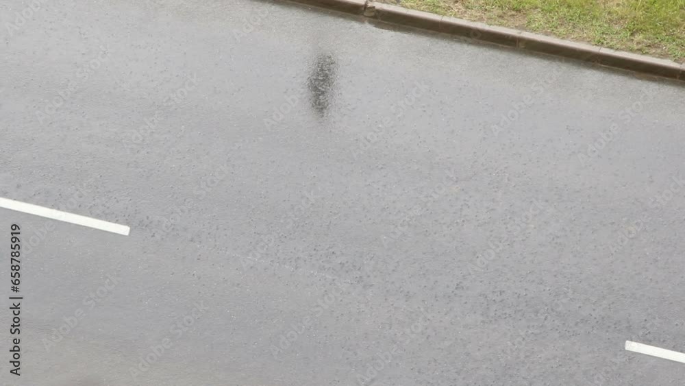 Heavy rain on asphalt road.
