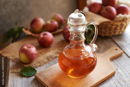 Apple cider vinegar with fresh apples on a table