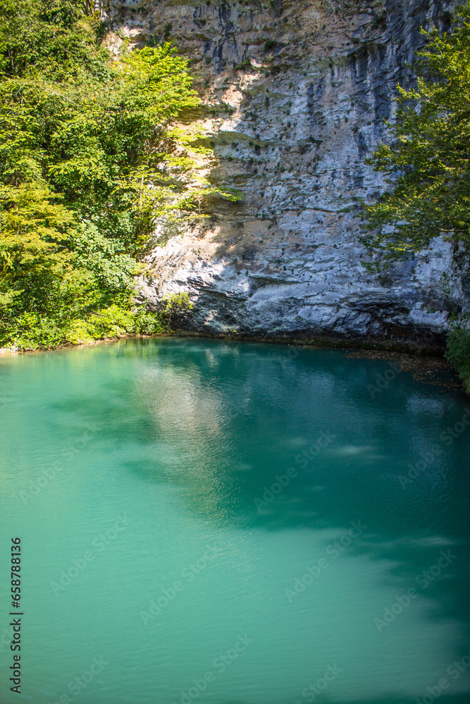 A beautiful blue lake in Abkhazia on a sunny summer day and a space to copy A beautiful blue lake in Abkhazia on a sunny summer day and a space to copy