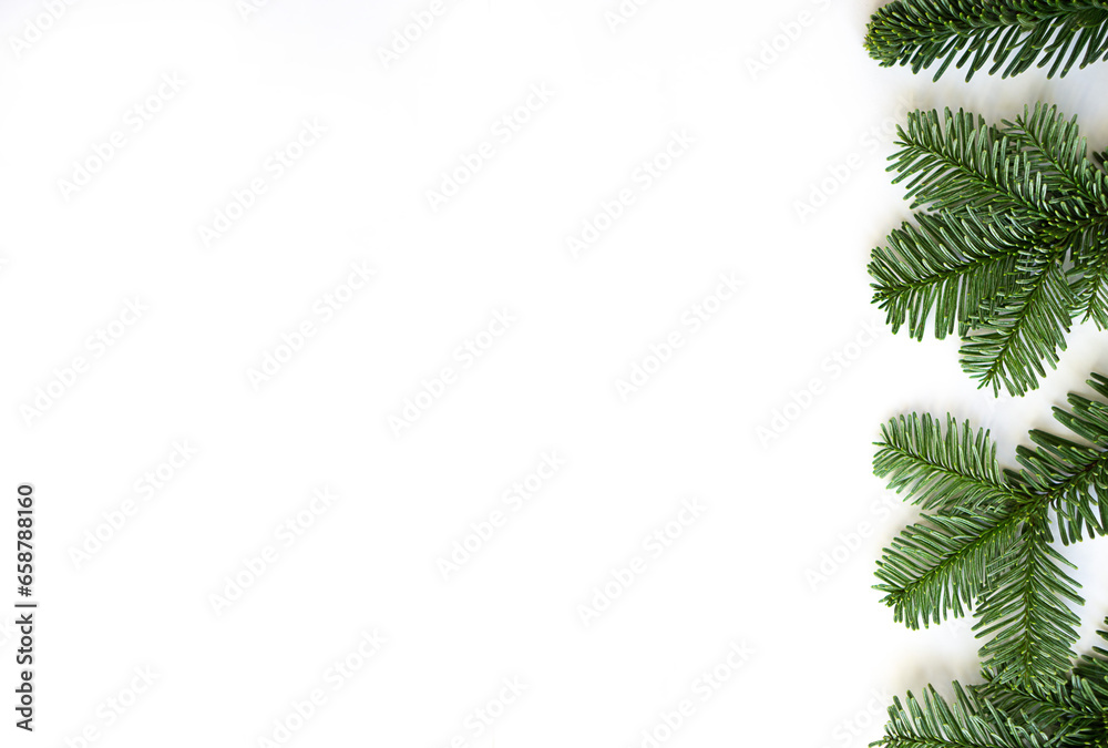 Christmas flat lay of fir branches to the right on white background with copy space. Christmas flat lay of fir branches to the right on white background with copy space.