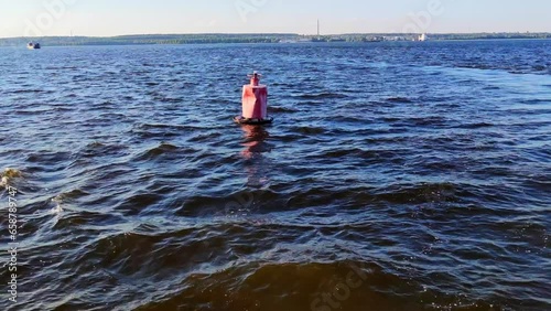 Red metal buoys on the water in the Volga River on the way of a ferry crossing in Kazan, Russia