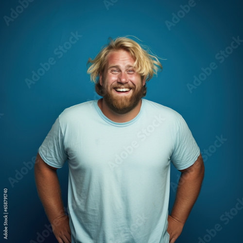 Face of overweight man looking at camera on blue background photo