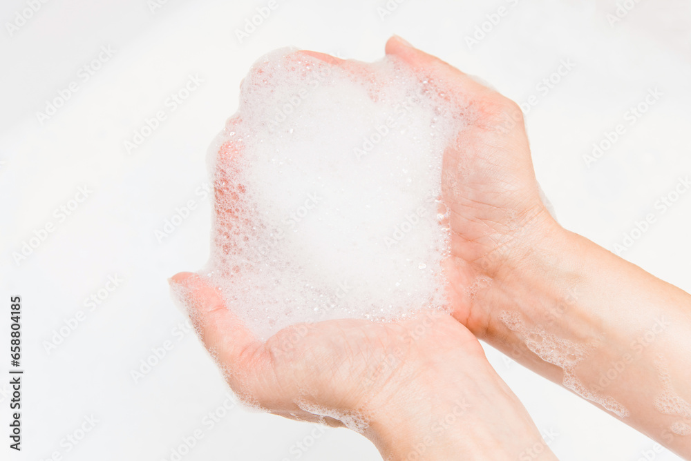 Fototapeta premium Female hand with soap foam close up view.