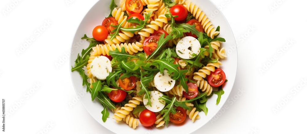 Italian cold pasta salad with fusilli tomato mozzarella olive and arugula With copyspace for text