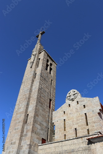 Stone tower with the cross of the Santuario da Penha in Guimaraes, Portugal. Vertical image.