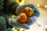 A lot of tangerines on a blue mittens in a Christmas night