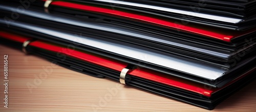 Piles of paper files organized with red and black clips With copyspace for text