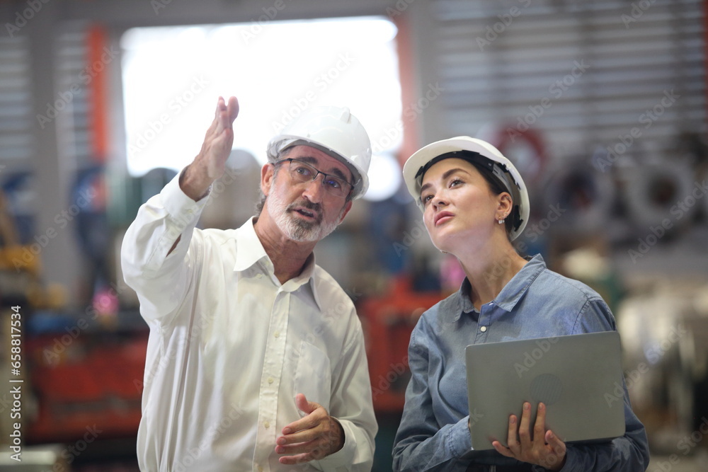 worker or engineer working in factory with safety uniform , safety hat and safety glasses , image is safety concept or happy workplace worker or engineer working in factory with safety uniform , safety hat and safety glasses , image is safety concept or happy workplace
