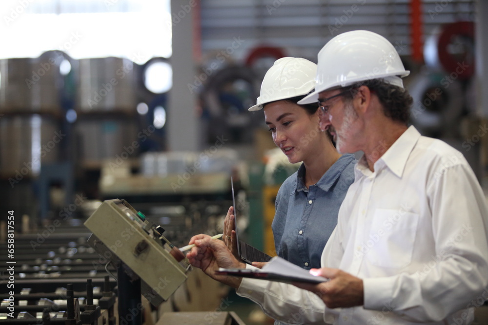 worker or engineer working in factory with safety uniform , safety hat and safety glasses , image is safety concept or happy workplace worker or engineer working in factory with safety uniform , safety hat and safety glasses , image is safety concept or happy workplace