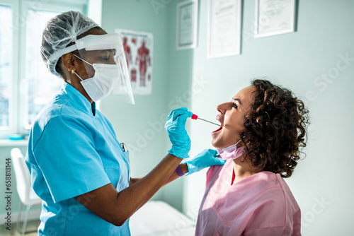 Healthcare Professional Conducting a Throat Swab Test on a Patient photo
