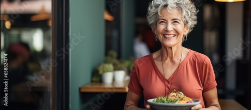 Elderly woman enjoying vegan meal at home caring for her body With copyspace for text