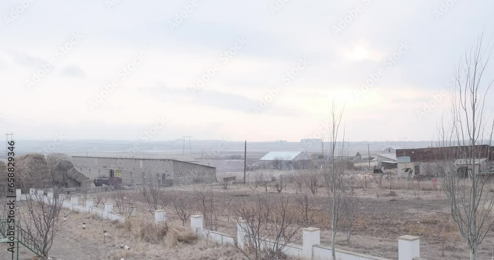 Explore the serene winter landscape of an Armenian village adorned with massive haystacks, a tranquil scene of rural life Explore the serene winter landscape of an Armenian village adorned with massive haystacks, a tranquil scene of rural life