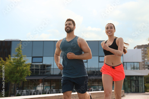 Healthy lifestyle. Happy couple running outdoors on sunny day