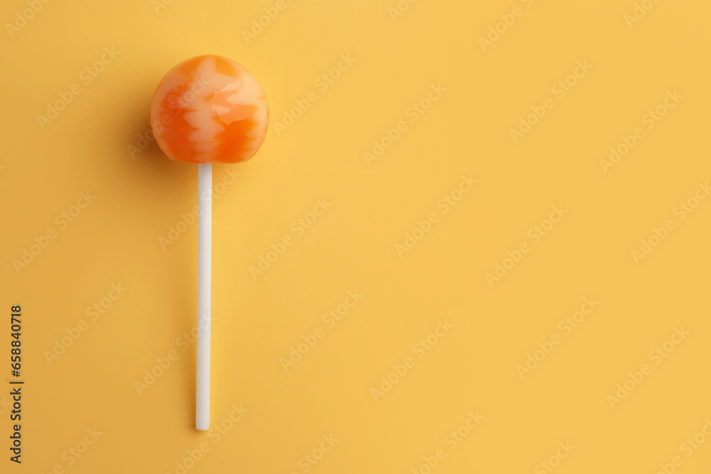 Tasty lollipop on orange background, top view. Space for text Tasty lollipop on orange background, top view. Space for text