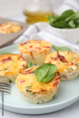 Freshly baked bacon and egg muffins with cheese on table, closeup