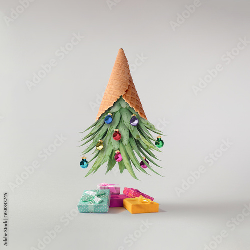 Creative New Year's composition with a pineapple tree, ice cream cones and Christmas decoration. Vacation concept. Modern collage on a white background. Creative art minimal aesthetics