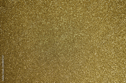 Fondo de brillos / textura glitter de color amarillo dorado. Se puede usar como fondo de año nuevo o navidad.