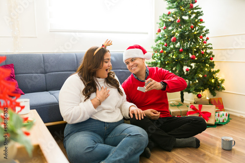 Cheerful couple getting engaged during christmas