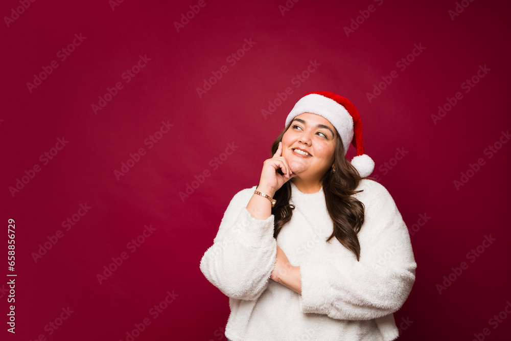 Pensive happy woman thinking about the christmas holidays Pensive happy woman thinking about the christmas holidays