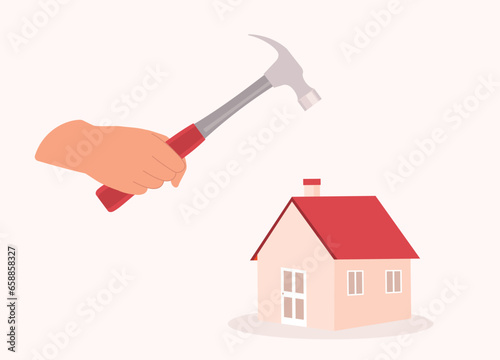 A Person’s Hand Holding Hammer Whacking Down The House. Close-Up.
