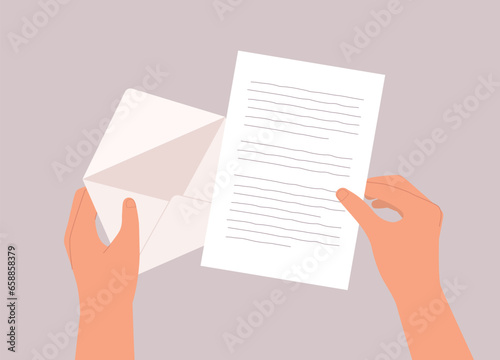 A Person’s Hand Opening A Letter From An Envelope. Close-Up.