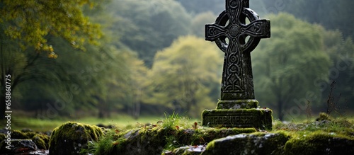 Graveyard in Glendalough Ireland with a Celtic cross With copyspace for text