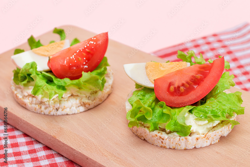 Rice Cake Sandwiches with Tomato, Lettuce and Egg on Wooden Cutting Board. Easy Breakfast. Diet Food. Quick and Healthy Sandwiches. Crispbread with Tasty Filling. Healthy Dietary Snack Rice Cake Sandwiches with Tomato, Lettuce and Egg on Wooden Cutting Board. Easy Breakfast. Diet Food. Quick and Healthy Sandwiches. Crispbread with Tasty Filling. Healthy Dietary Snack