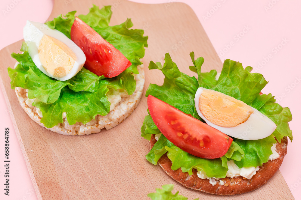 Rice Cake Sandwiches with Tomato, Lettuce and Egg on Wooden Cutting Board. Easy Breakfast. Diet Food. Quick and Healthy Sandwiches. Crispbread with Tasty Filling. Healthy Dietary Snack Rice Cake Sandwiches with Tomato, Lettuce and Egg on Wooden Cutting Board. Easy Breakfast. Diet Food. Quick and Healthy Sandwiches. Crispbread with Tasty Filling. Healthy Dietary Snack