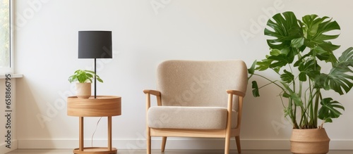 Minimalist living room with a wooden framed botanic poster round table and palm plant With copyspace for text