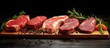 Assorted selection of raw Black Angus Prime meat steaks on wooden board With copyspace for text