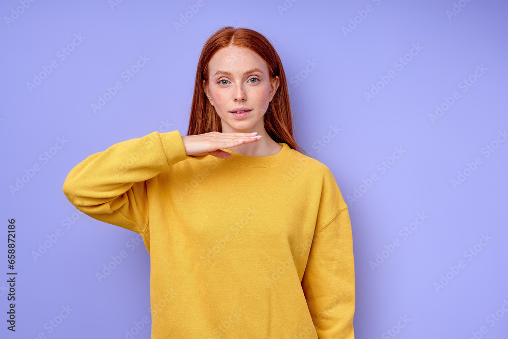 attractive ginger girl using gesture to communicate talk chat with friends, close up portrait isolated blue background studio shot