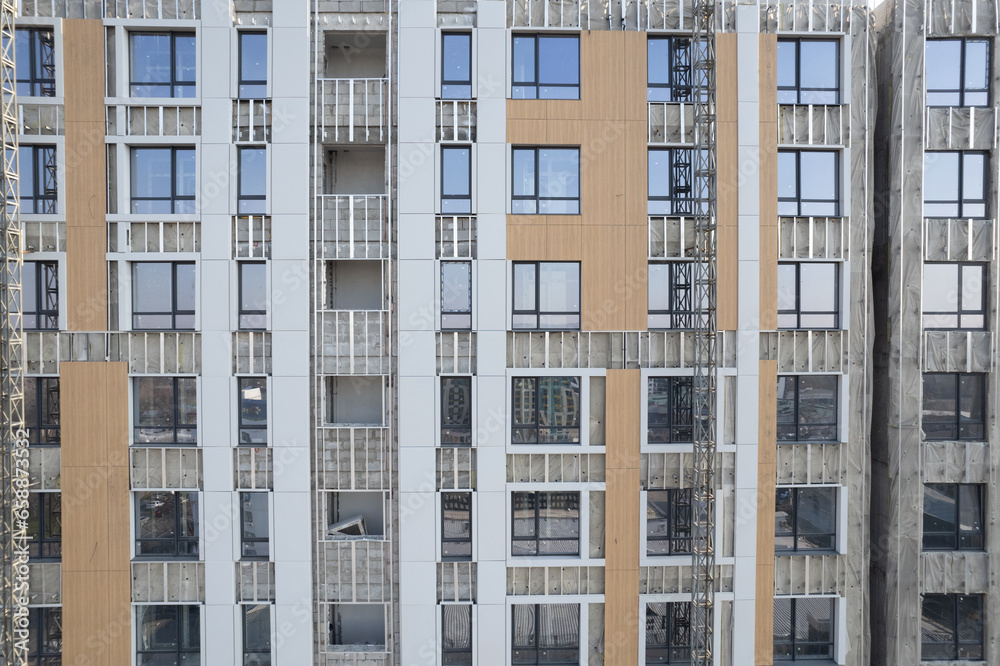Fototapeta premium Facade work on a building under construction