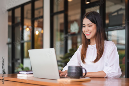 Businesswomen using laptop to typing financial data and working about new startup in outside office