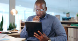 Businessman, hold and tablet while thinking in office, late and work on app, telemarketing or analytics. Black person, face and reading of reports of data, online or documents for customer support
