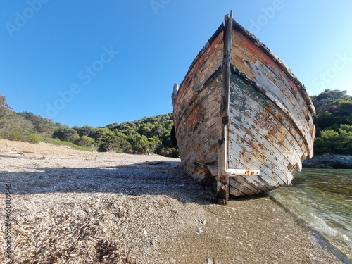 shipwreck on the beach of agalypa of skyros in greece pine trees clear transparent water in the sea photo