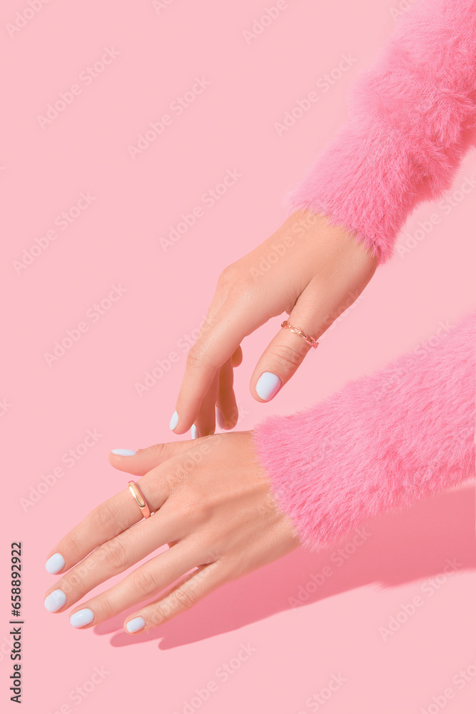 Womans hands with white manicure on pink background - obrazy, fototapety, plakaty 