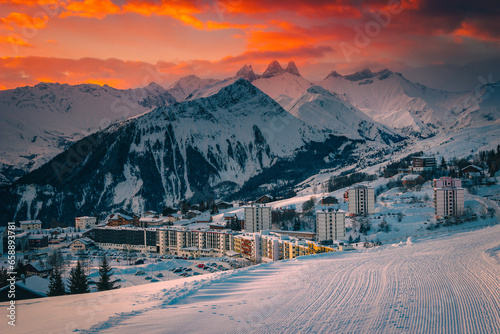 Alpine ski resort with buildings at sunrise, La Toussuire, France