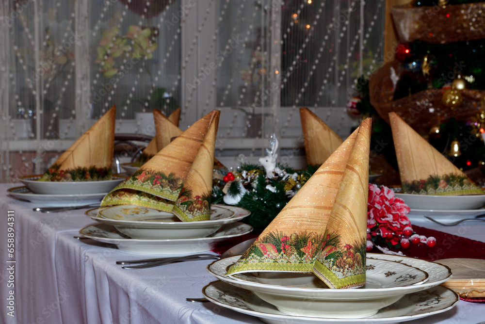 Close-up detail of a decorated Christmas table in a home during night