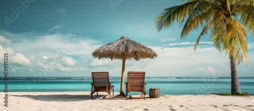 Tropical vacation with beach chairs umbrella and palms With copyspace for text