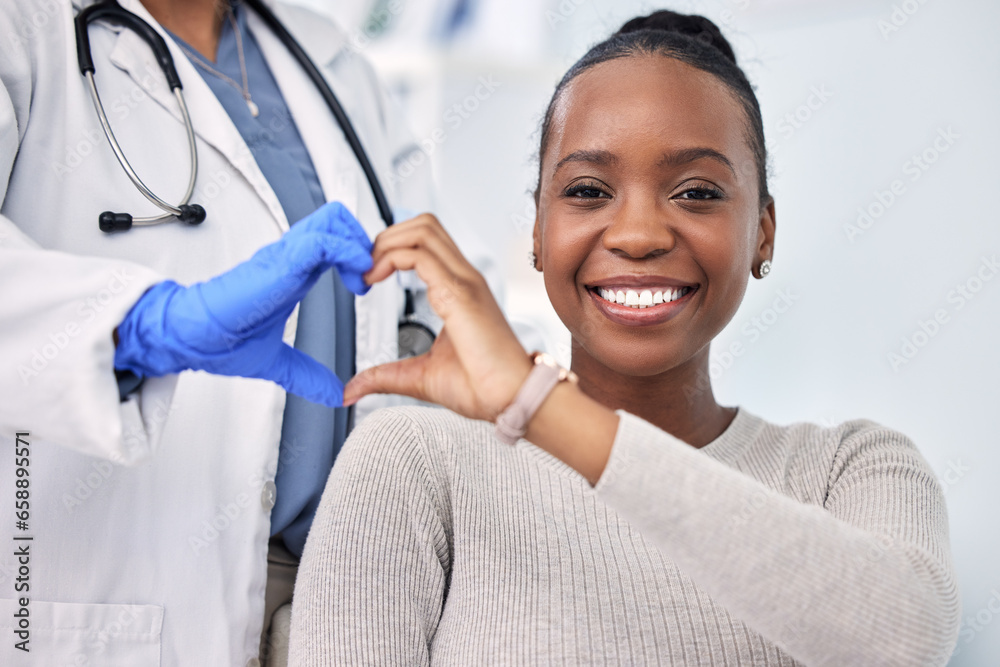 © D Theron/peopleimages.com - Black woman, patient and doctor with smile, consultation and heart emoji for cardio health, checkup and appointment. Happiness, support and wellness for medicine, healthcare and physical examination