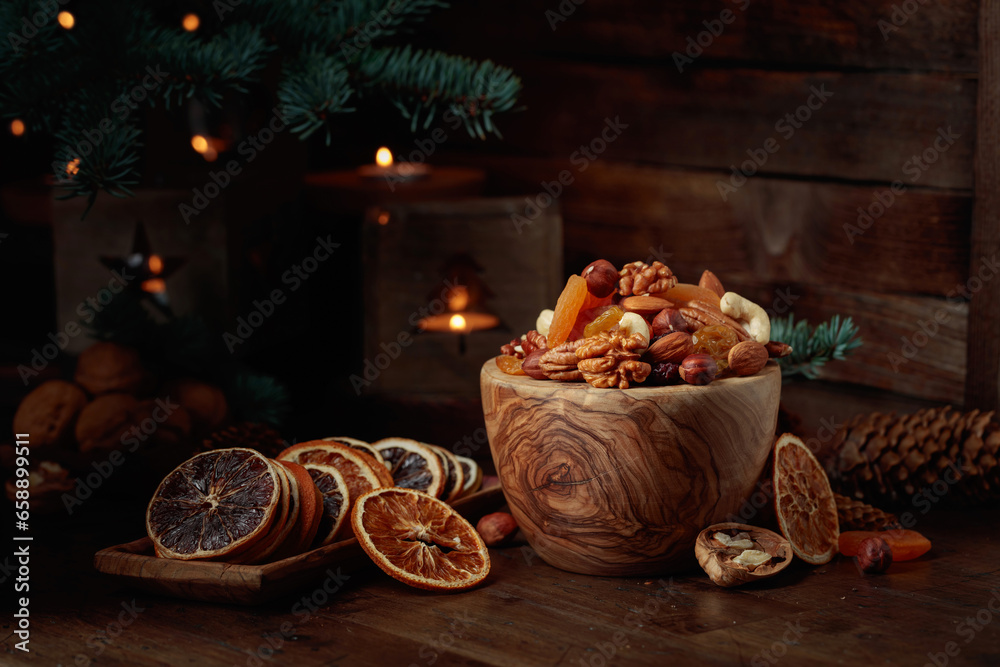 Dried fruits and assorted nuts on an old wooden table.