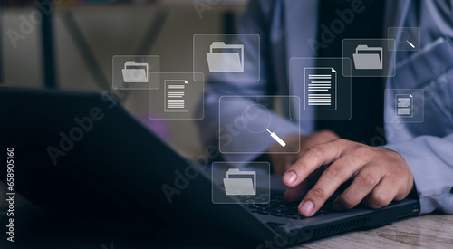 Document management system concept, business man holding folder and document icon software, searching and managing files online document database, for efficient archiving and company data.