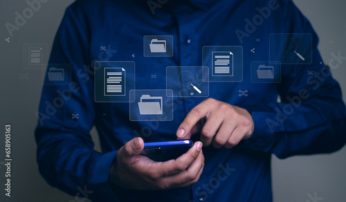 Document management system concept, business man holding folder and document icon software, searching and managing files online document database, for efficient archiving and company data.