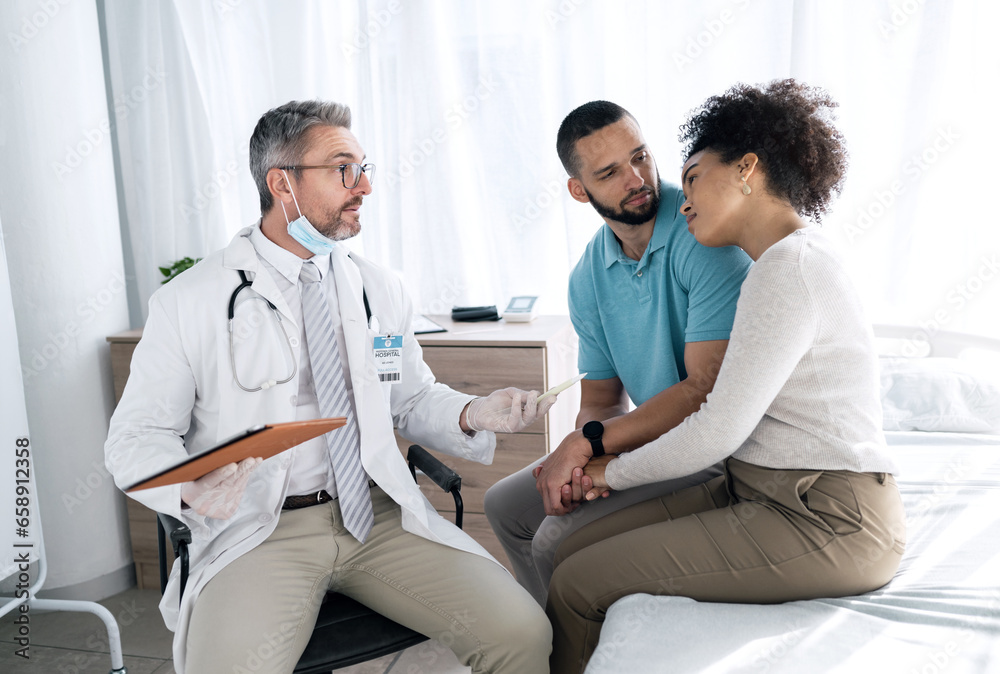Obraz premium Hospital, doctor and couple with sad news for medical service, comfort and empathy for diagnosis. Healthcare, consulting and person with man and woman holding hands for support, wellness or results