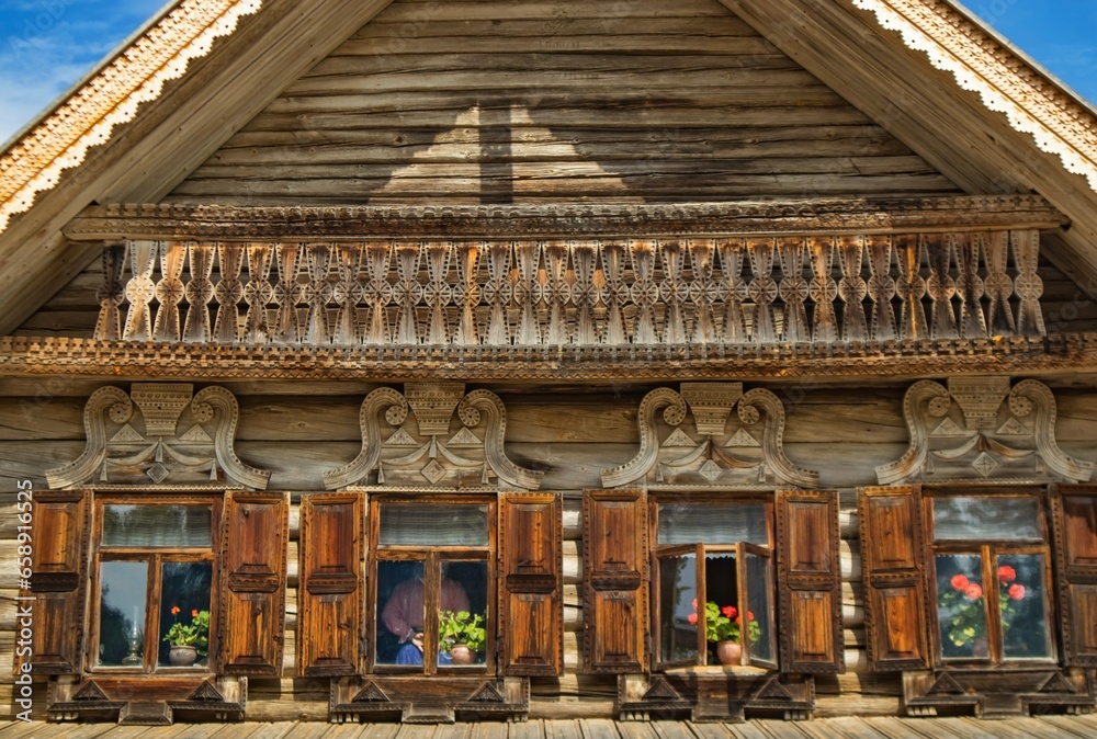 Facade of an ancient wooden house in Russian traditional style in the Museum of Wooden Architecture of Vitoslavlitsa, Veliky Novgorod, Russia